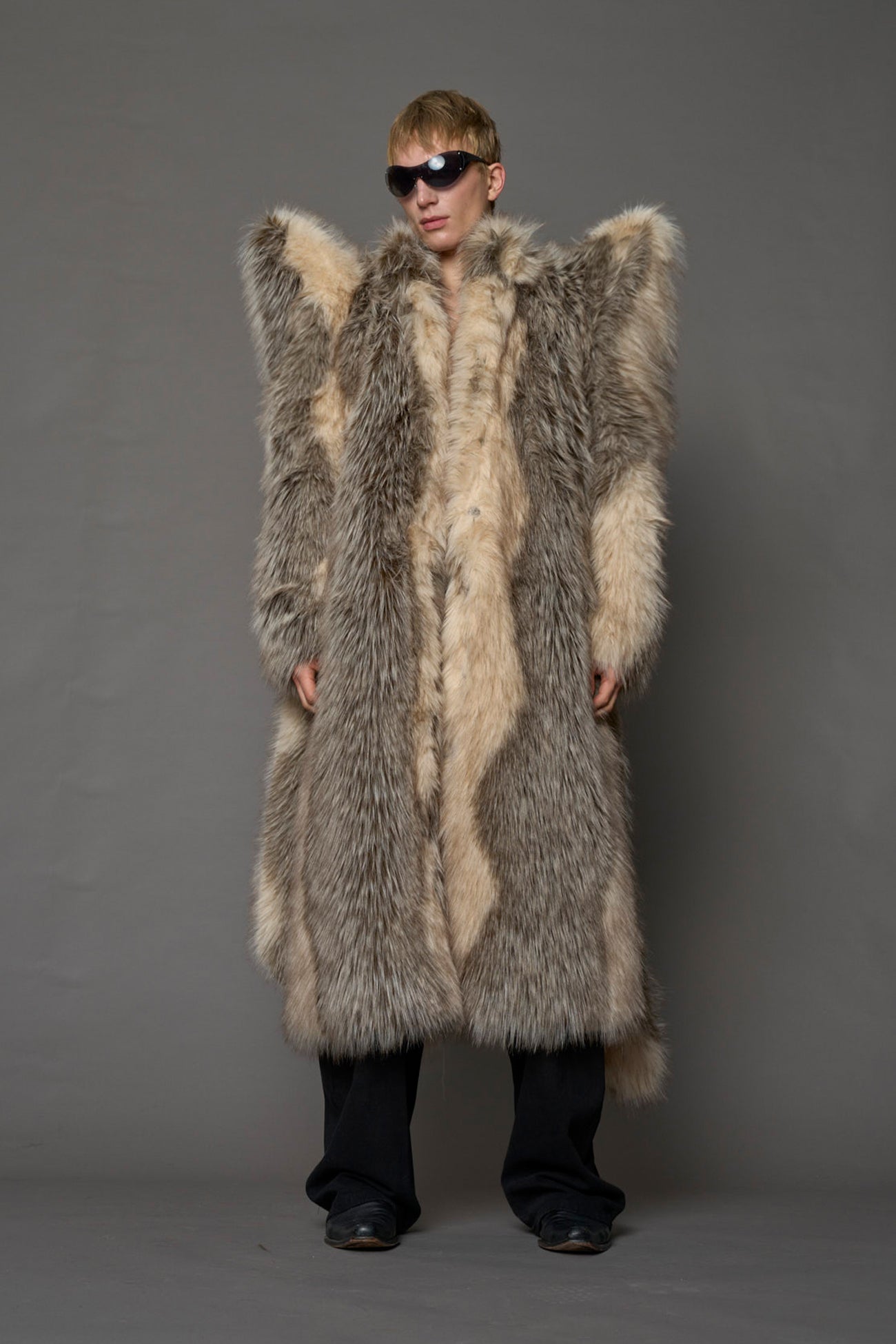model wearing brown spike shoulder long faux fur coat