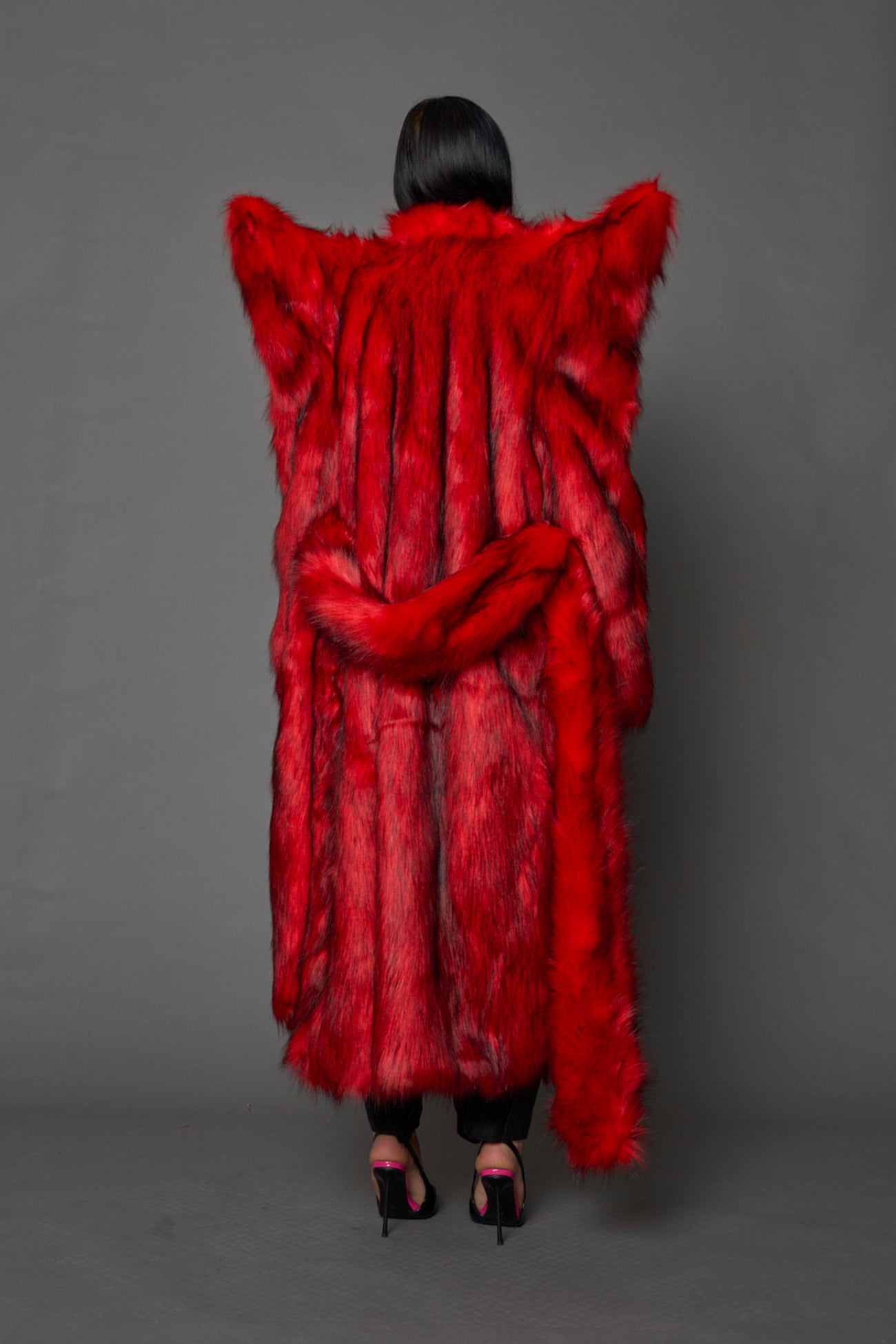model wearing red spike shoulder long faux fur coat