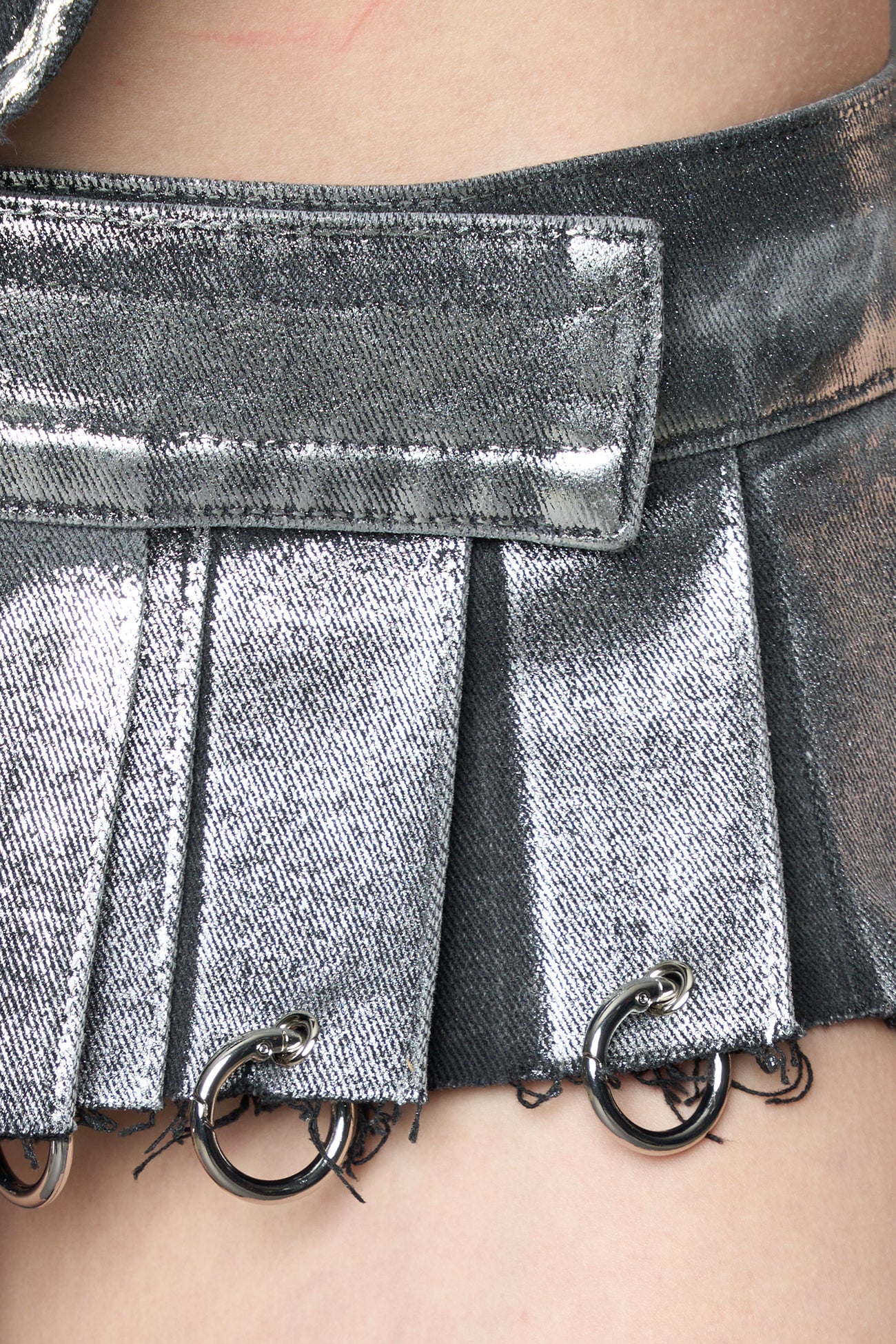 model wearing silver plated mini pleated denim skirt