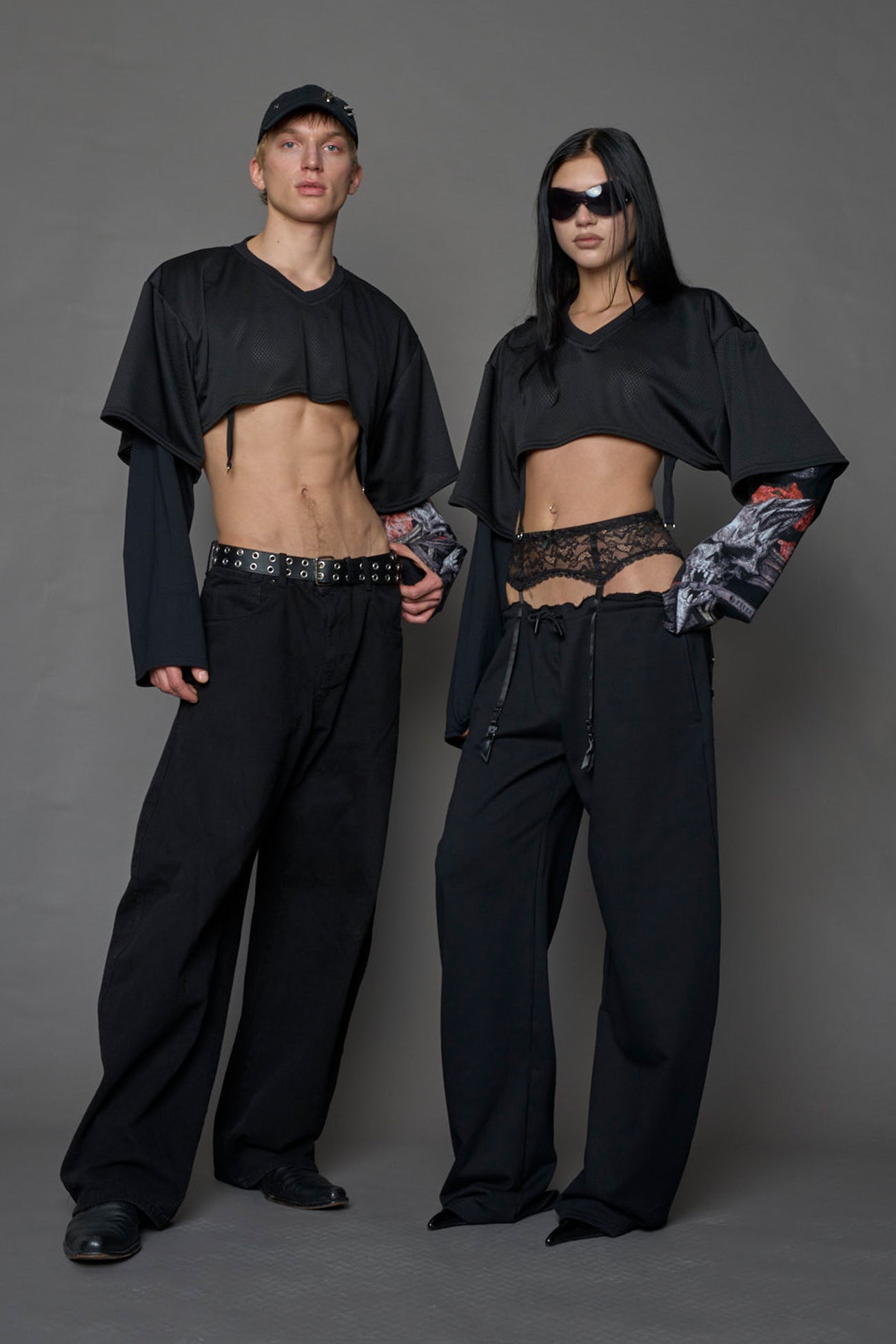male and female model wearing a black cropped football inspired T-Shirt with a goth-inspired print