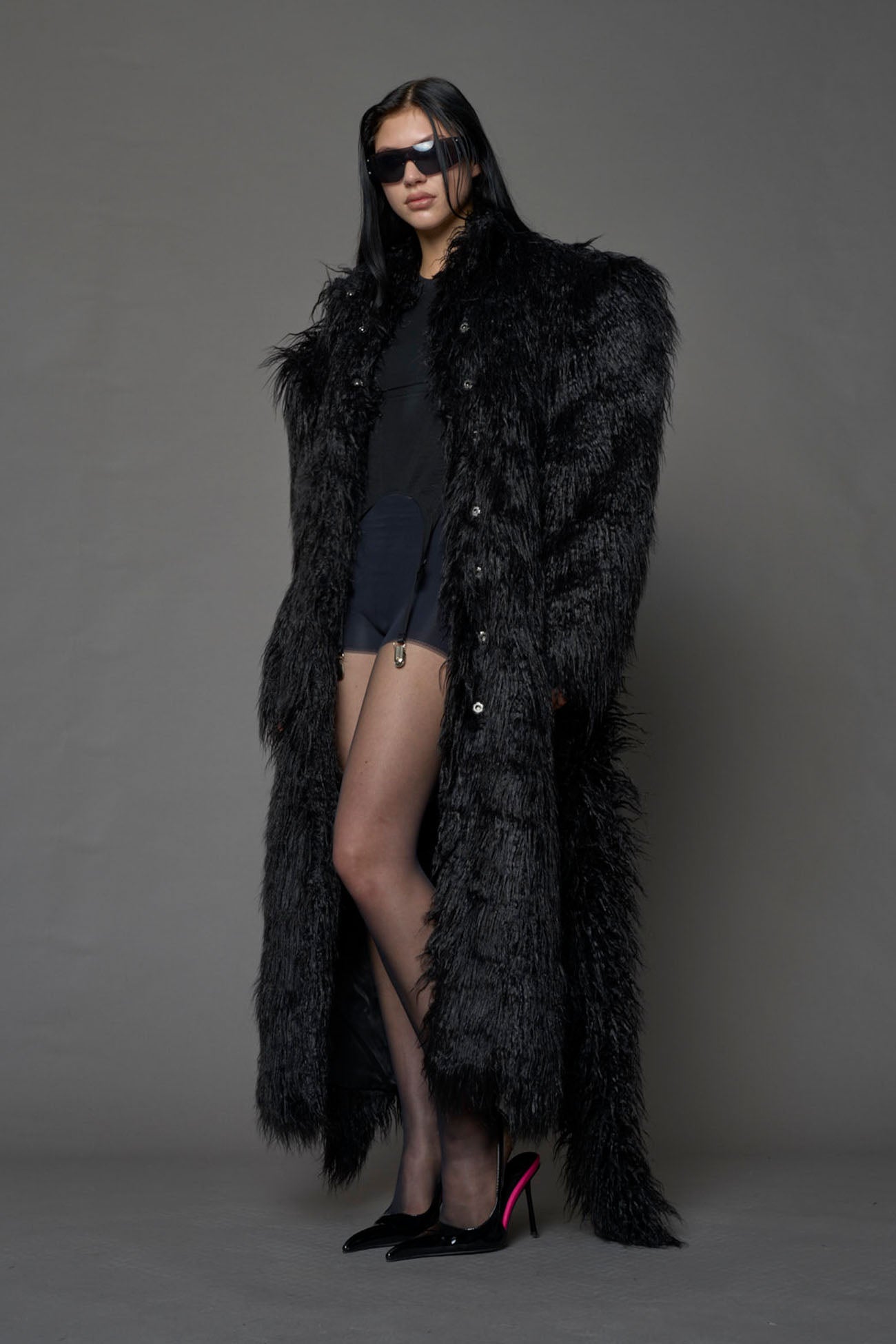black faux fur coat with shoulder pads and belt
