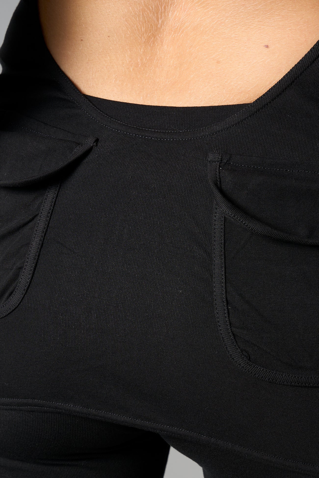 model wearing black soft jersey short dress with hood and backless cut out