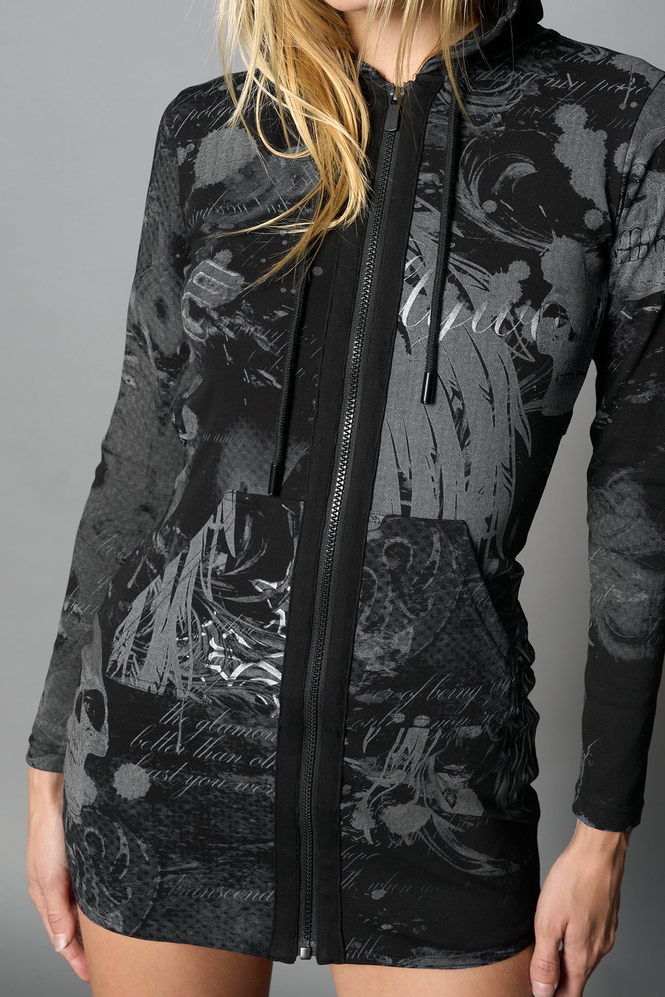 model wearing black print soft jersey short dress with hood and backless cut out