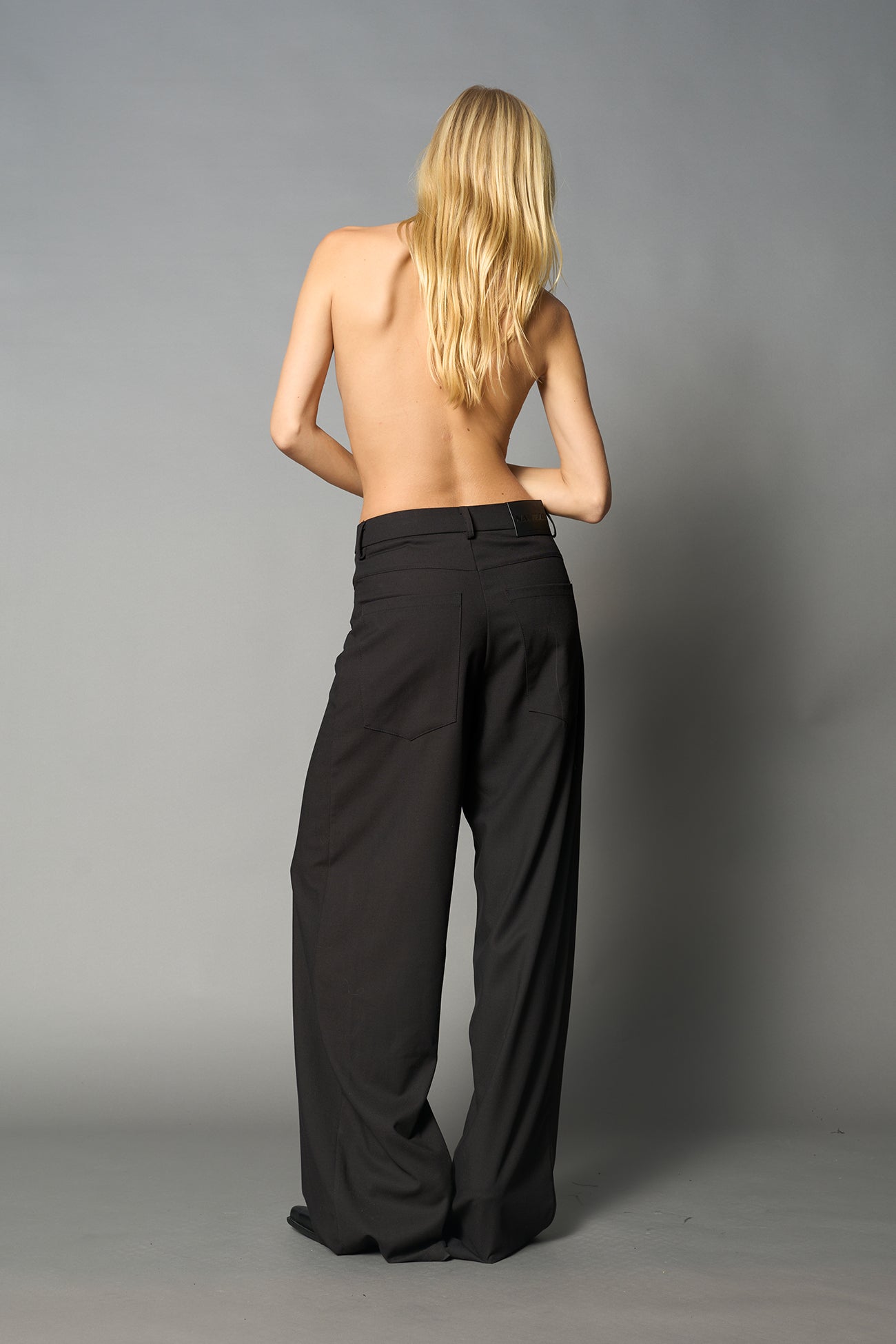 model wearing baggy wool suiting pants black
