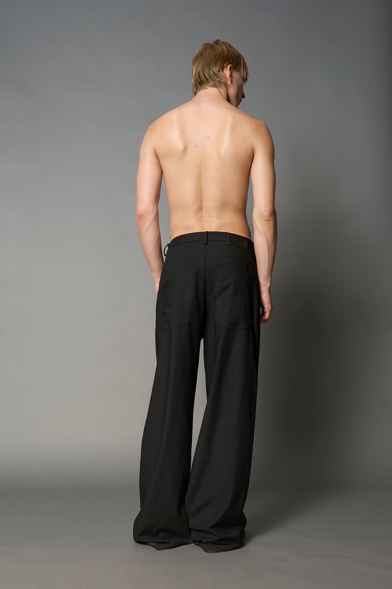 model wearing baggy wool suiting pants black