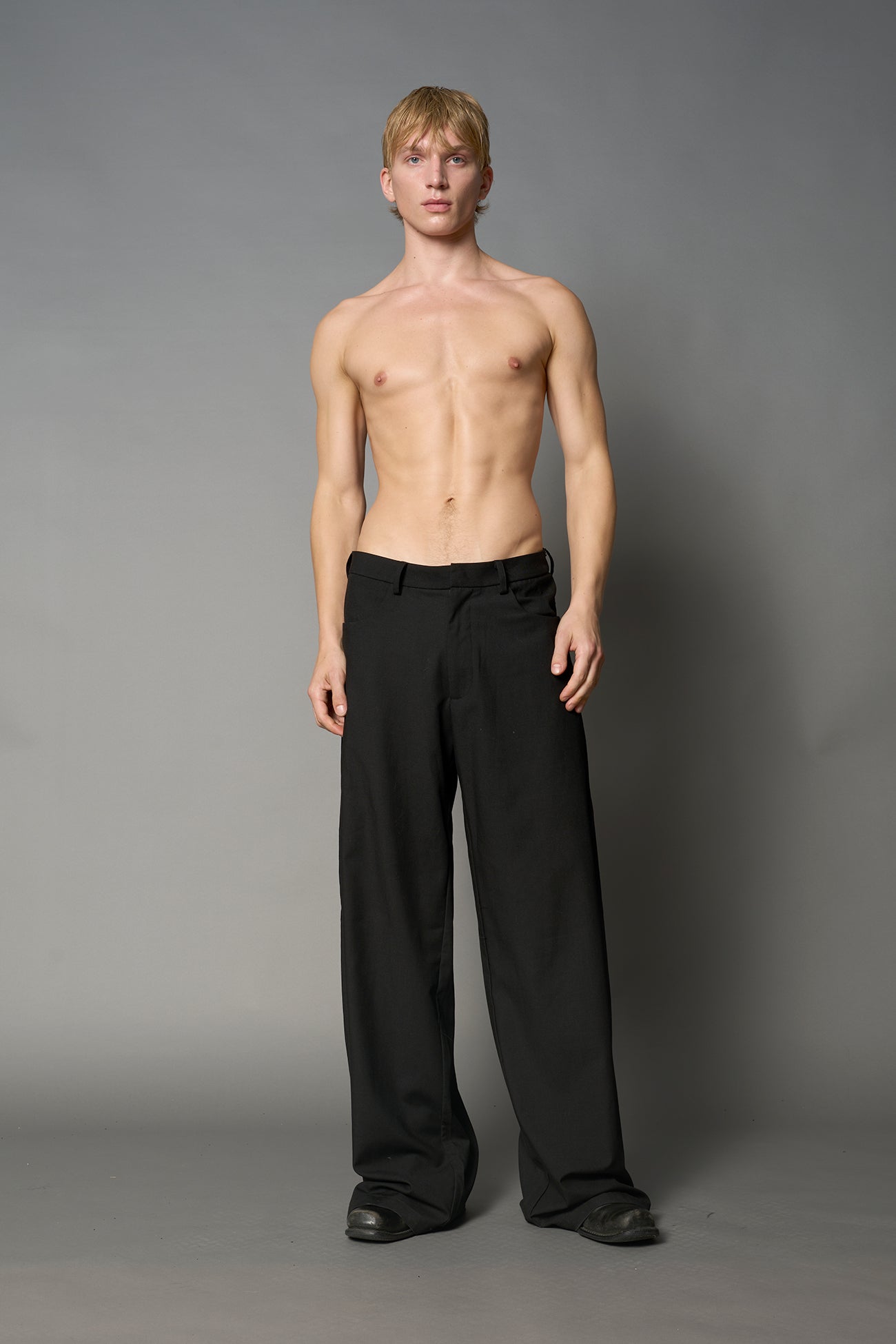 model wearing baggy wool suiting pants black