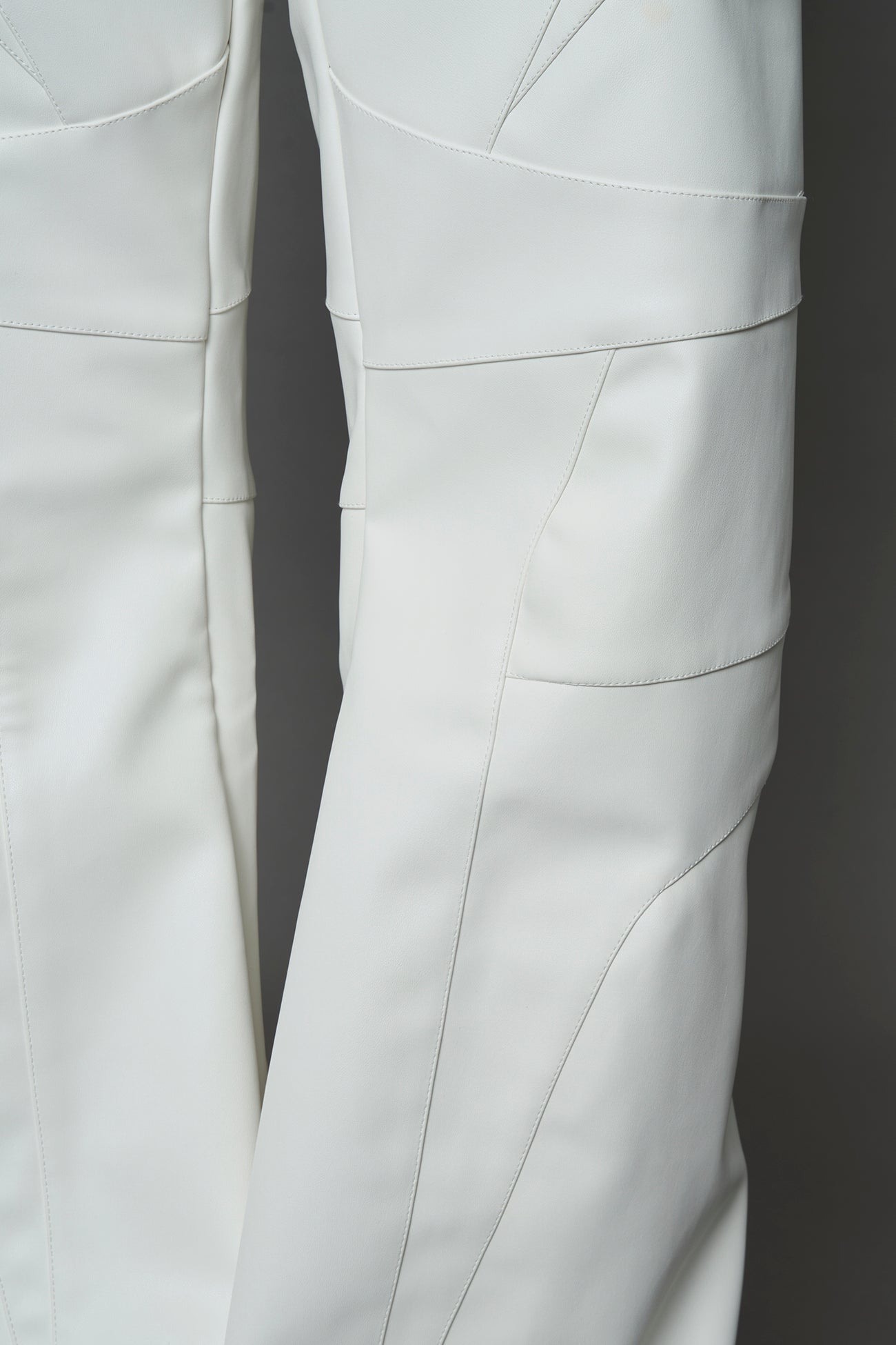 two models wearing white vegan leather pants with thong detail