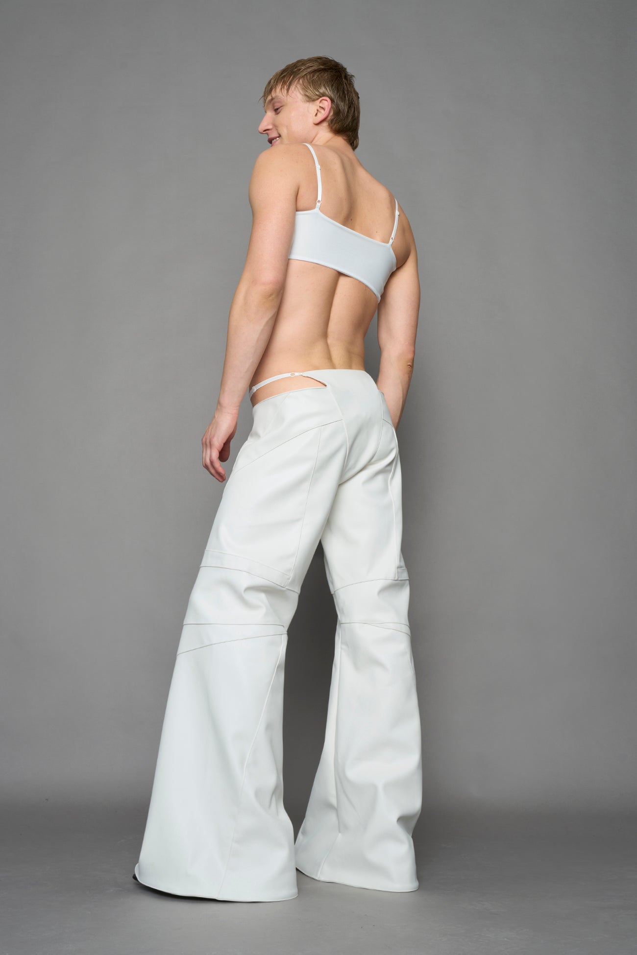 two models wearing white vegan leather pants with thong detail