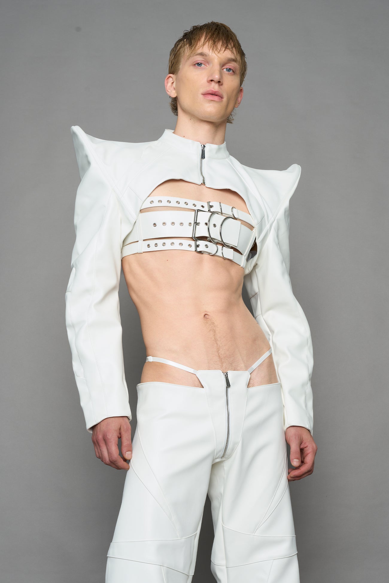 model wearing white vegan leather bolero jacket with spiked shoulder details