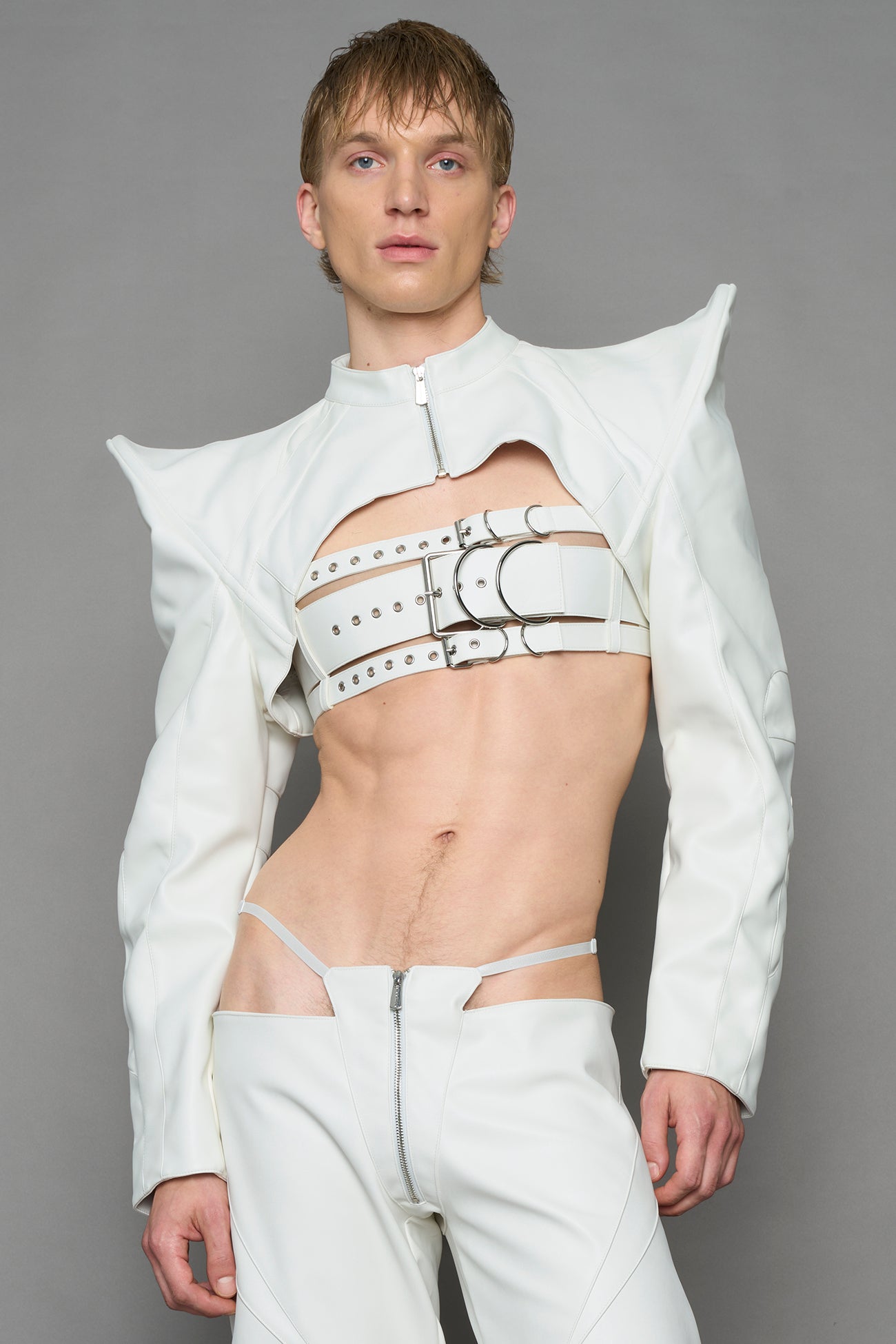 model wearing white vegan leather bolero jacket with spiked shoulder details