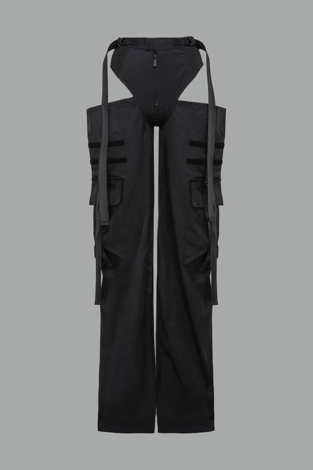 Black nylon cargo trousers with exposed high-cut panty waist, cut-out hips, oversized pockets, and adjustable utility straps – edgy streetwear and festival pants.
