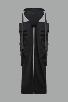 Black nylon cargo trousers with exposed high-cut panty waist, cut-out hips, oversized pockets, and adjustable utility straps – edgy streetwear and festival pants.