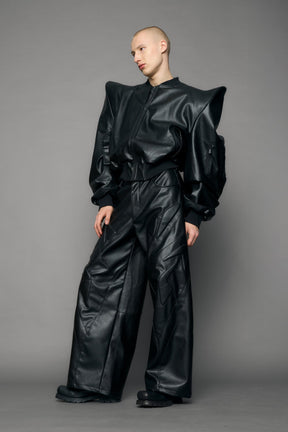 model wearing black pu leather bomber jacket with sharp shoulder design