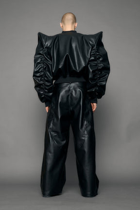 model wearing black pu leather bomber jacket with sharp shoulder design