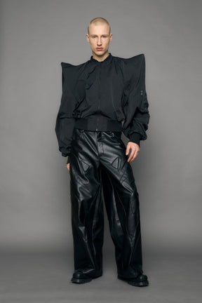 model wearing black bomber jacket with sharp shoulder design