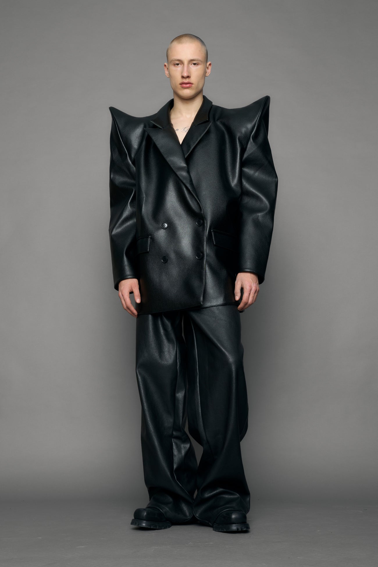 model wearing black pu leather blazer with sharp shoulder design