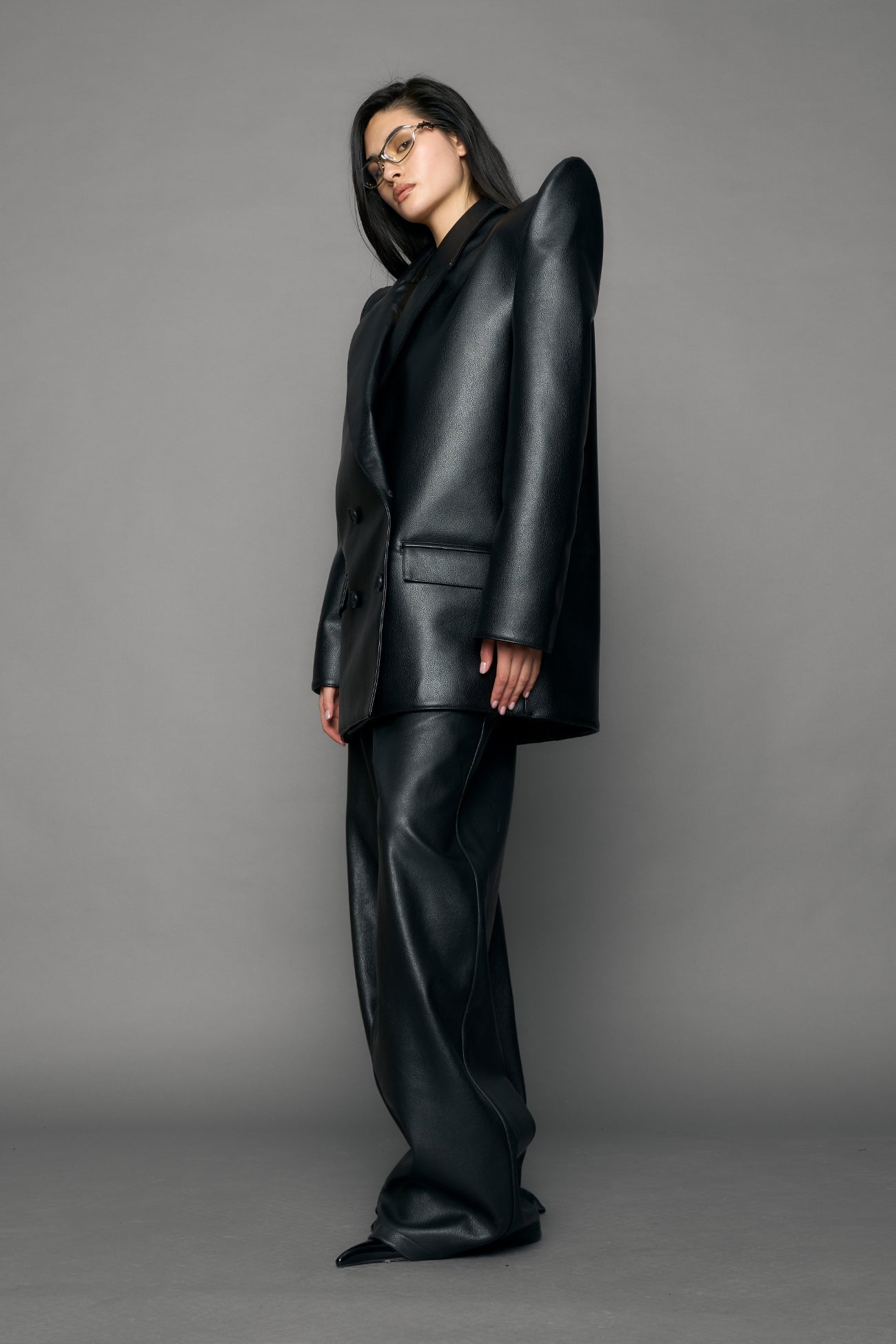model wearing black pu leather blazer with sharp shoulder design