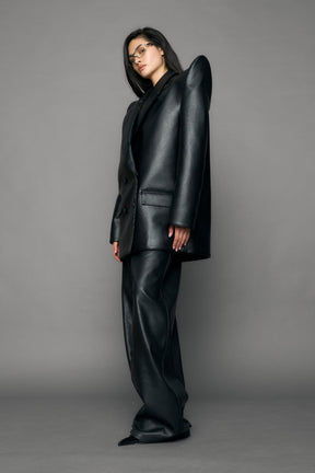 model wearing black pu leather blazer with sharp shoulder design