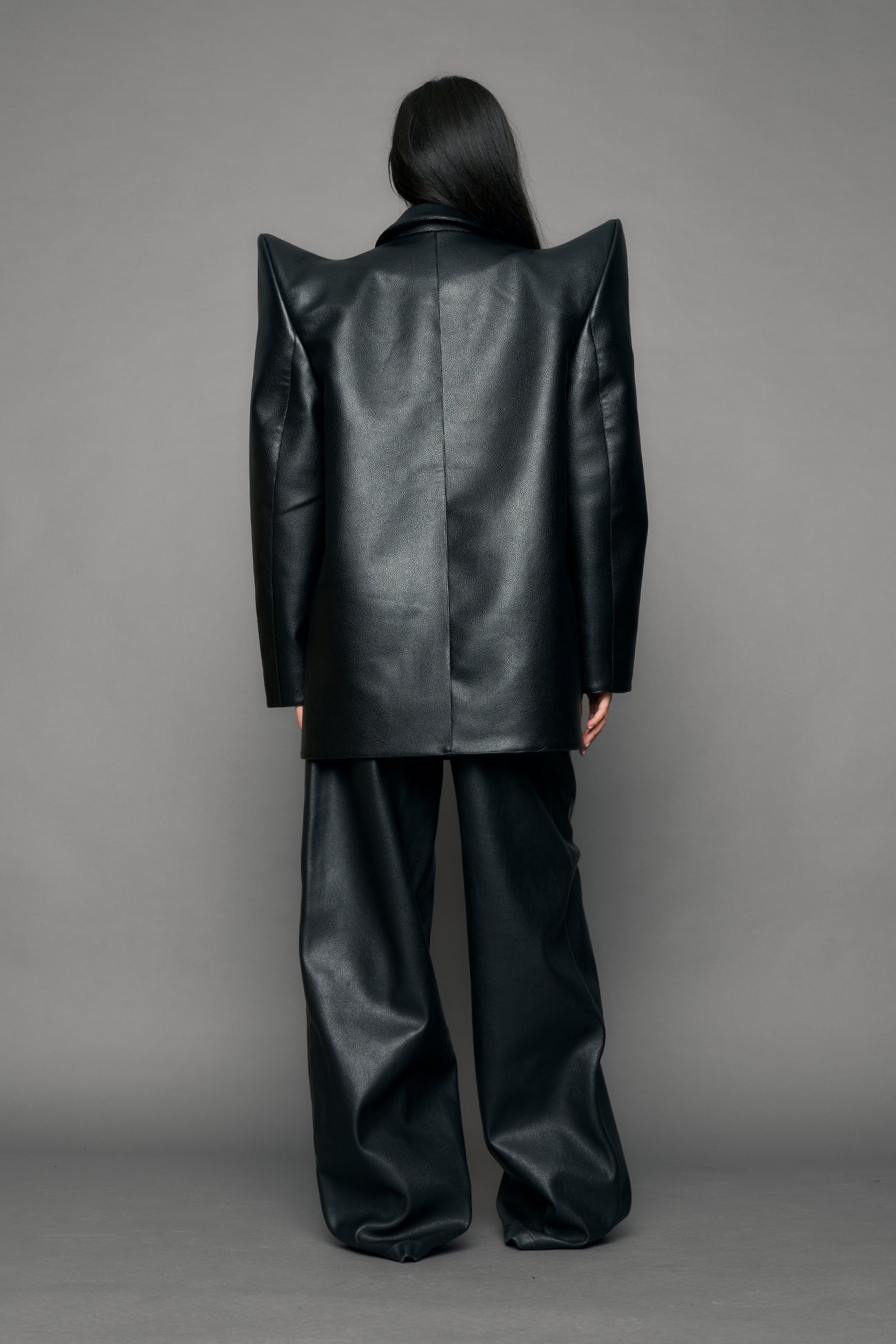 model wearing black pu leather blazer with sharp shoulder design