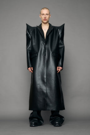 model wearing black pu leather coat with sharp shoulder design