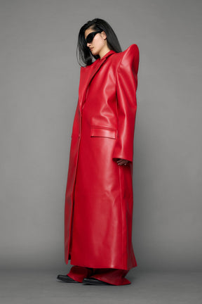 model wearing red pu leather coat with sharp shoulder design