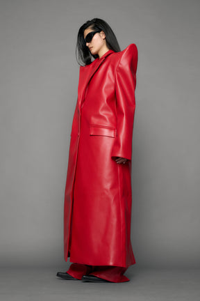 model wearing red pu leather coat with sharp shoulder design