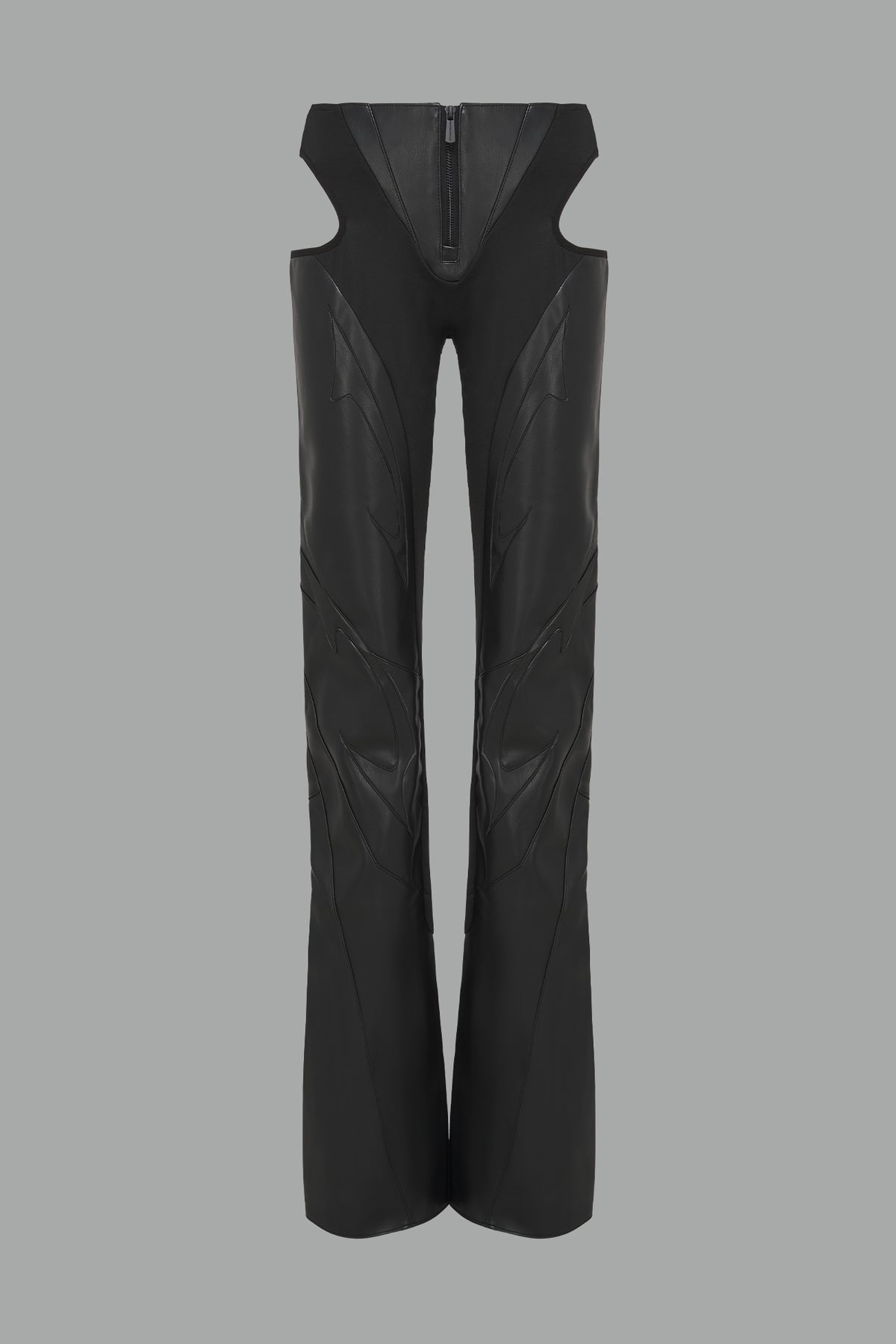Black cut-out flare pants with graphic details, vegan leather panels, and low-rise waist – edgy motocross-inspired trousers for men’s streetwear or festival looks.