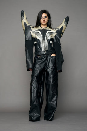 model wearing a motocross jacket with silver and black accents on a gray background