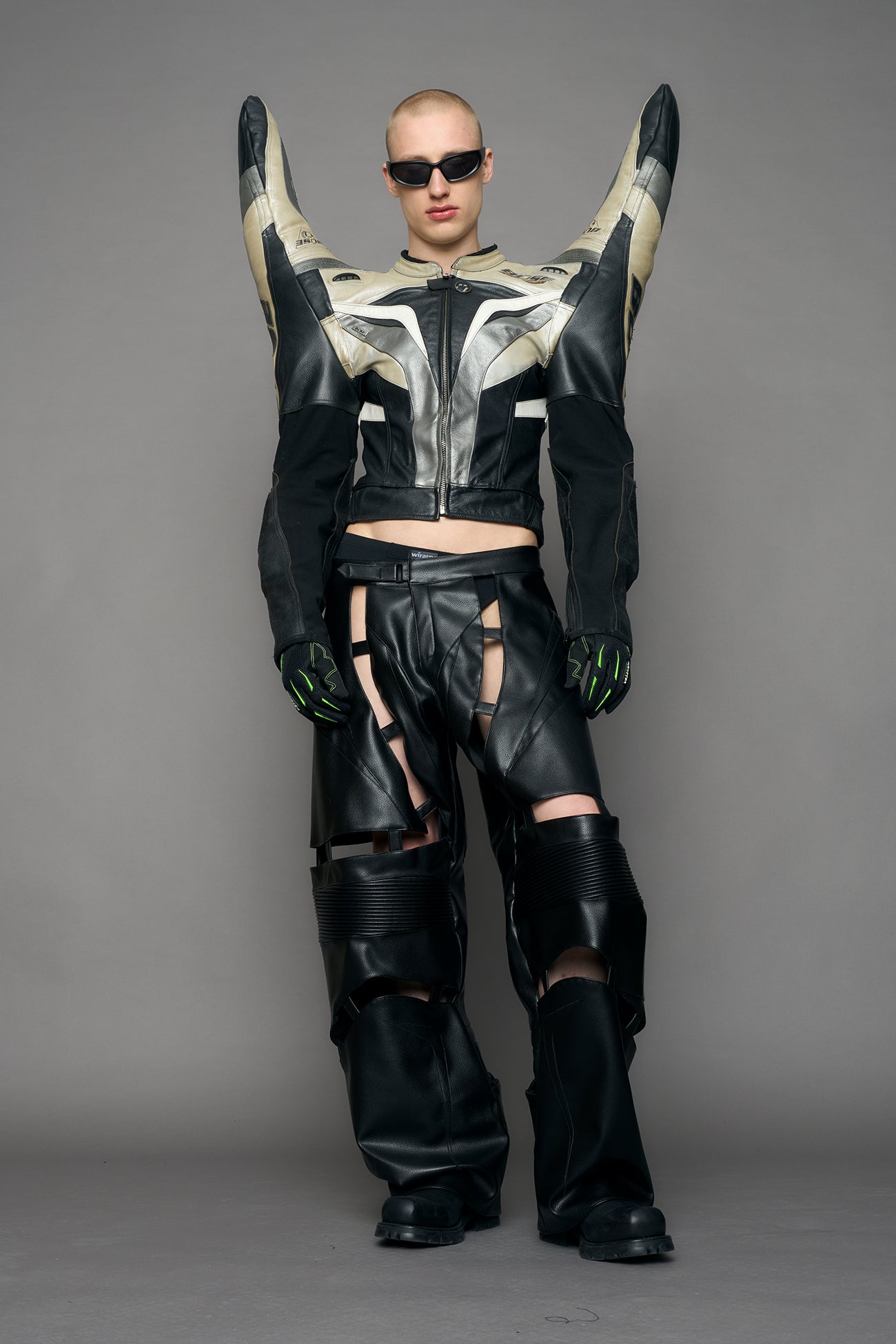 model wearing a motocross jacket with red and black accents on a gray background