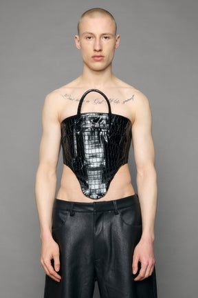 model wearing black croc pu leahter corset with handbag design 