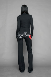 black crazy jersey pants with high waist rib waistband drawstring and back graphic print on model studio ecom photo