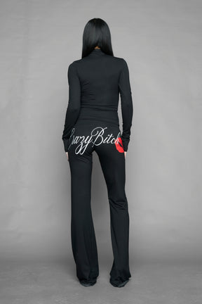 black crazy jersey pants with high waist rib waistband drawstring and back graphic print on model studio ecom photo