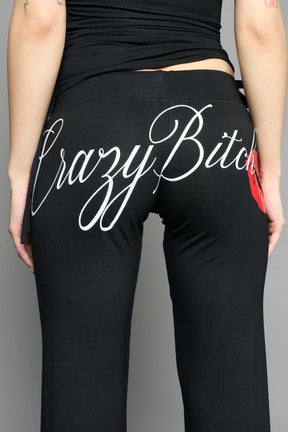 black crazy jersey pants with high waist rib waistband drawstring and back graphic print on model studio ecom photo