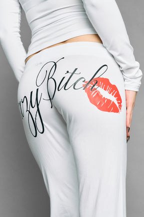 white crazy jersey pants with high waist rib waistband drawstring and back graphic print on model studio ecom photo