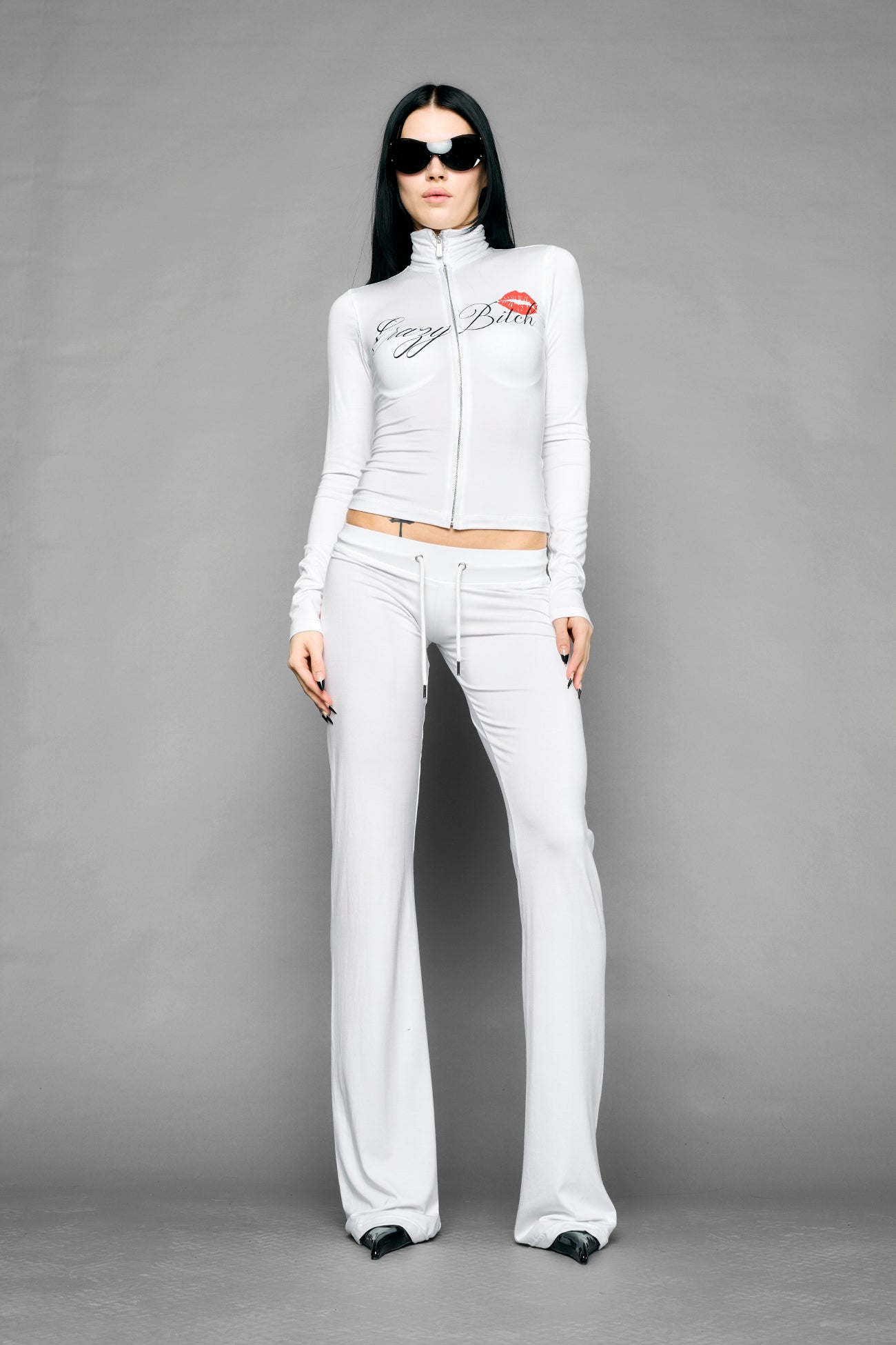 white crazy jersey pants with high waist rib waistband drawstring and back graphic print on model studio ecom photo