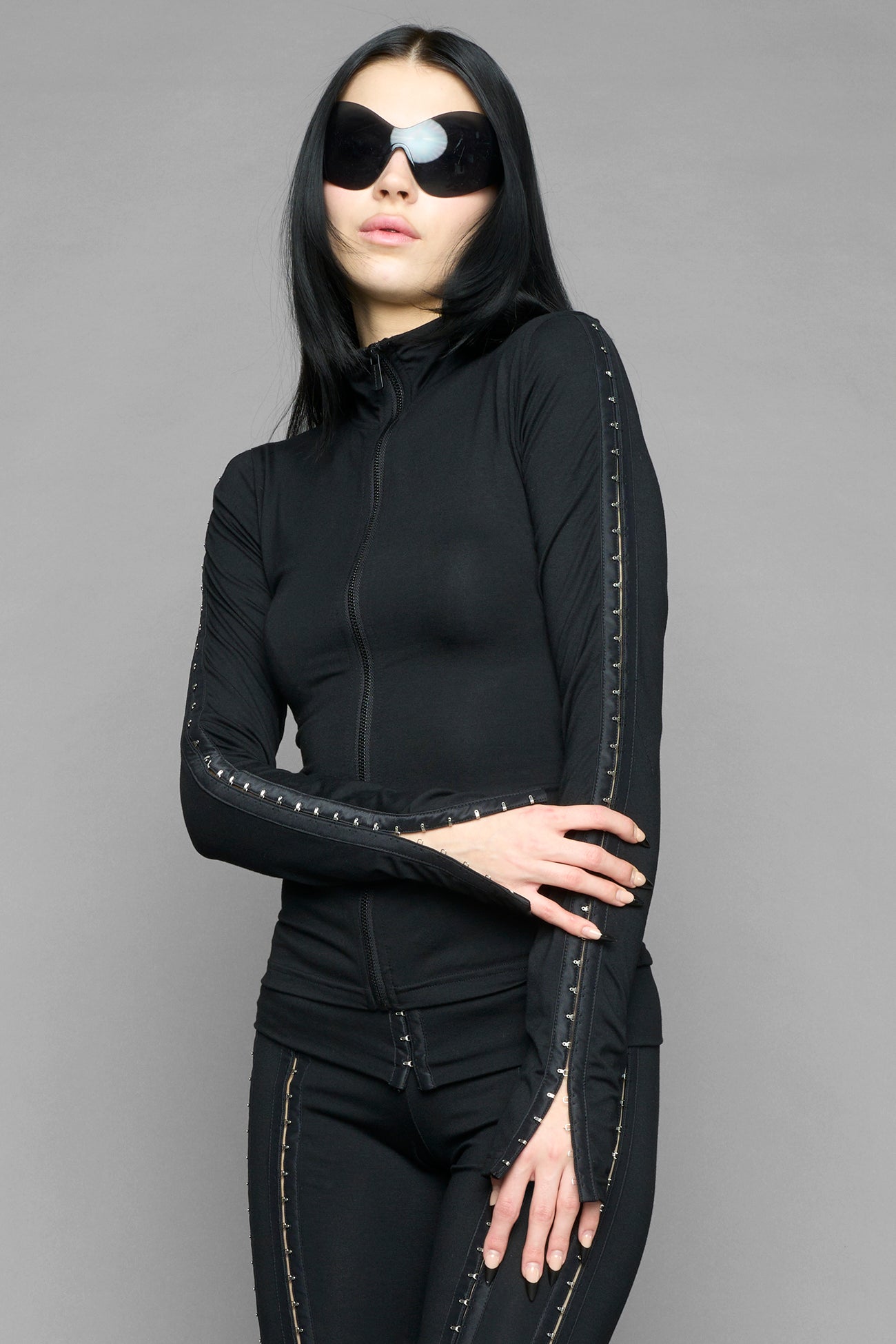 black hook and eye zip up jacket in soft jersey fabric with fitted silhouette worn by model studio ecommerce image