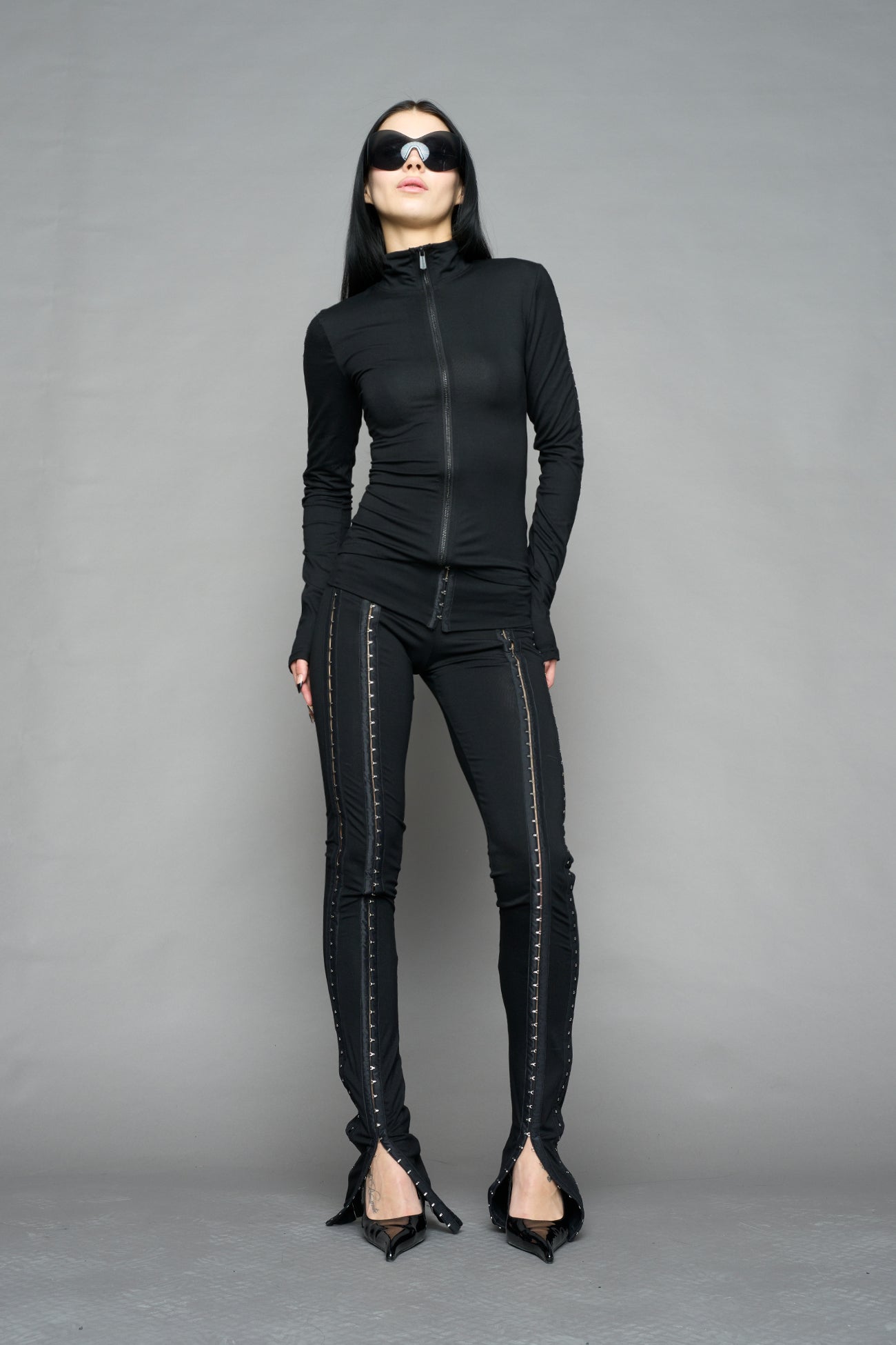 black hook and eye zip up jacket in soft jersey fabric with fitted silhouette worn by model studio ecommerce image