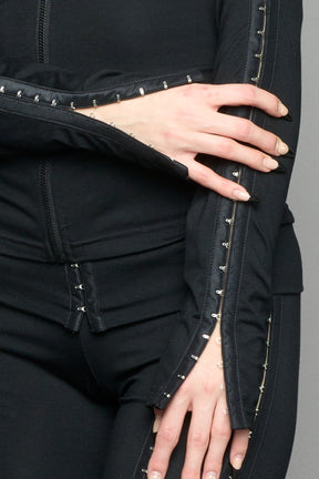 black hook and eye zip up jacket in soft jersey fabric with fitted silhouette worn by model studio ecommerce image