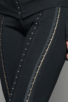 black hook tape jersey pants with slim fit and hook and eye detailing along legs worn by model studio ecommerce image