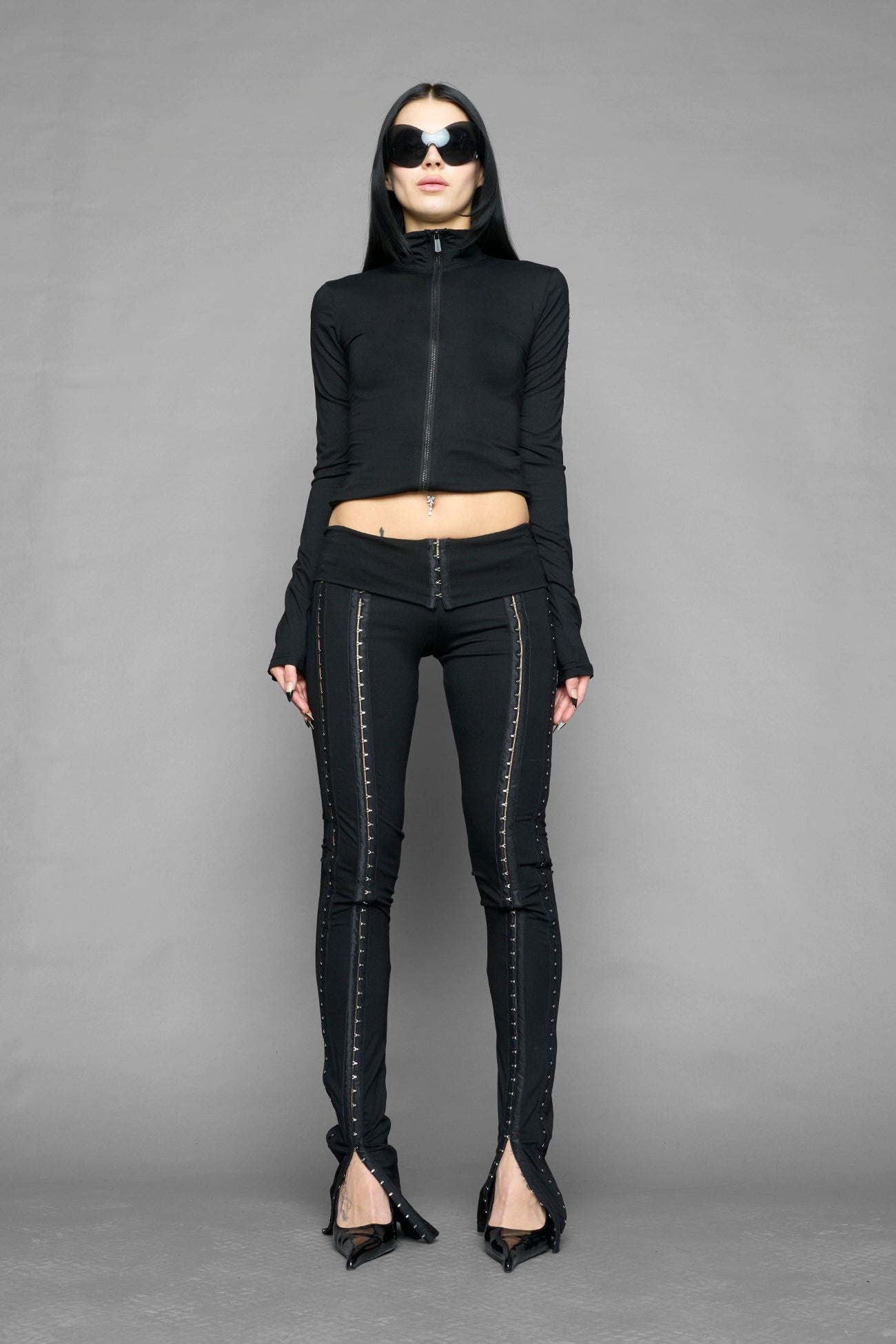 black hook tape jersey pants with slim fit and hook and eye detailing along legs worn by model studio ecommerce image