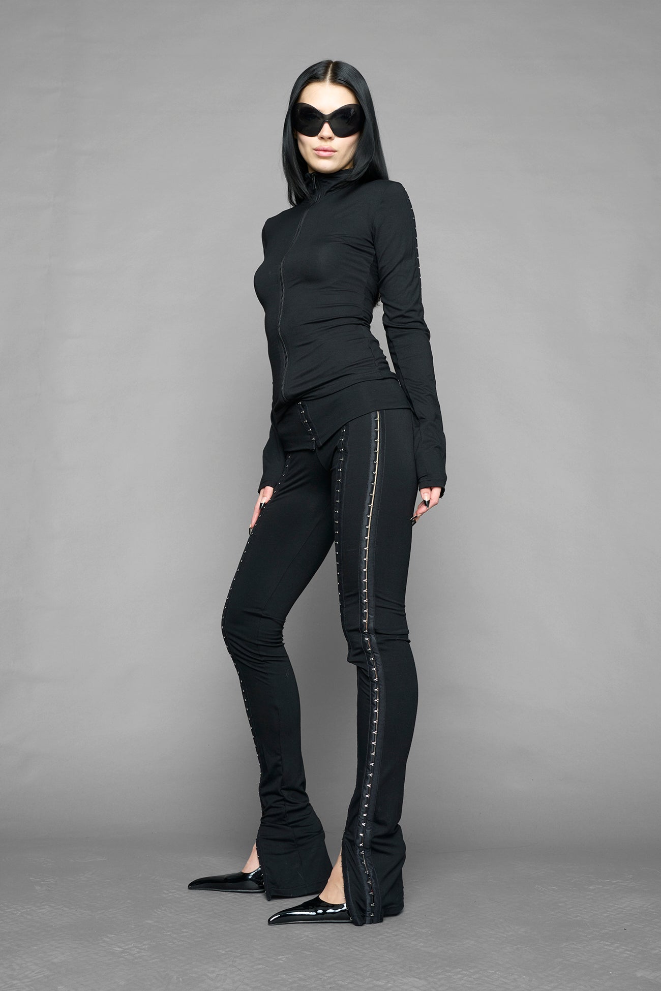 black hook and eye zip up jacket in soft jersey fabric with fitted silhouette worn by model studio ecommerce image