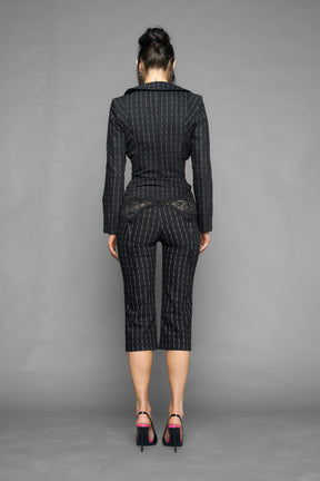 model wearing black pinstripe draped blazer black