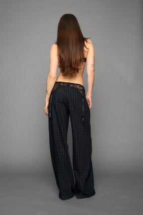 model wearing black print baggy suiting pants with garter lace waist detail