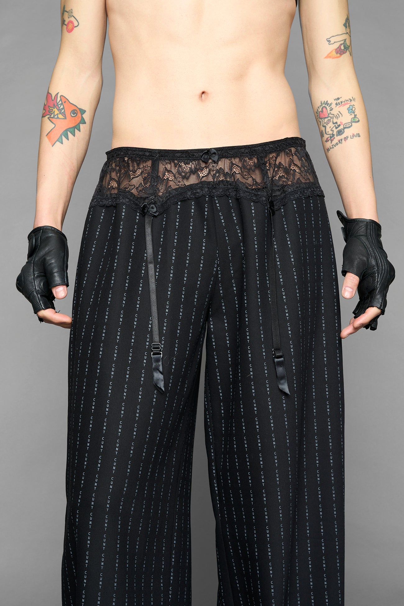 model wearing black print print baggy suiting pants with garter lace waist detail