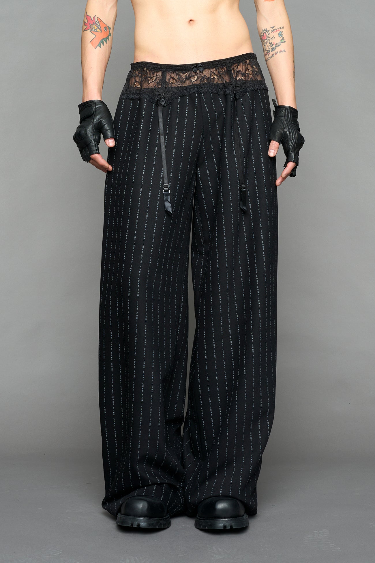 model wearing black print baggy suiting pants with garter lace waist detail