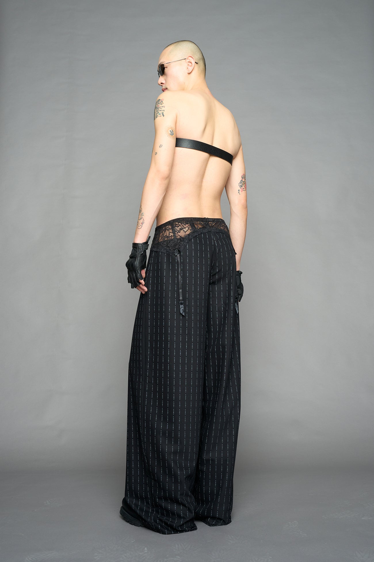 model wearing black print print baggy suiting pants with garter lace waist detail