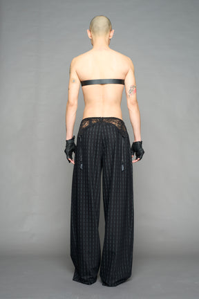 model wearing black print print baggy suiting pants with garter lace waist detail