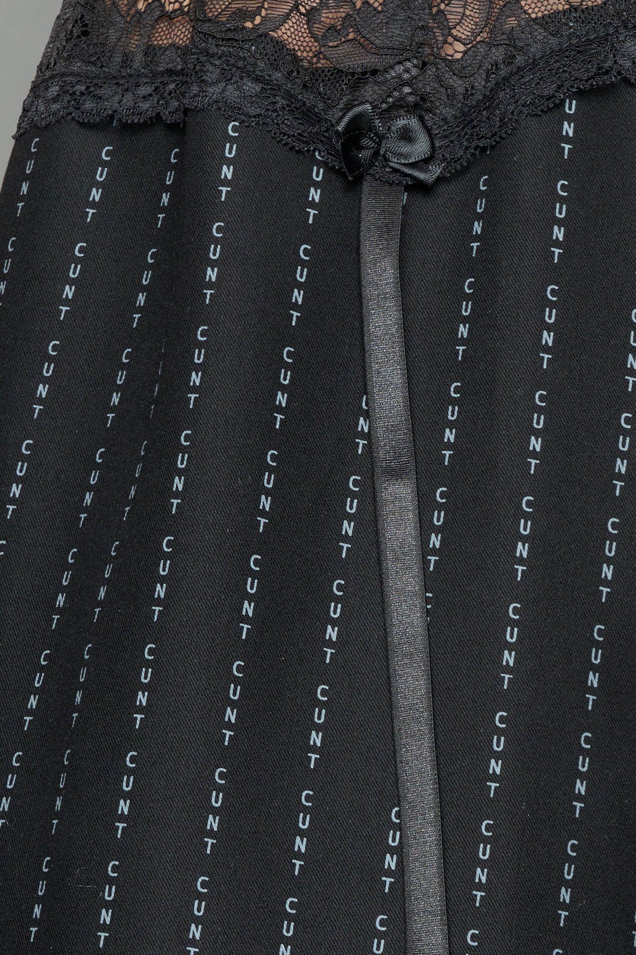 model wearing black print baggy suiting pants with garter lace waist detail