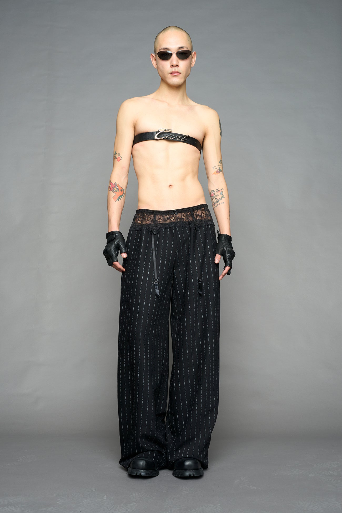 model wearing black print baggy suiting pants with garter lace waist detail