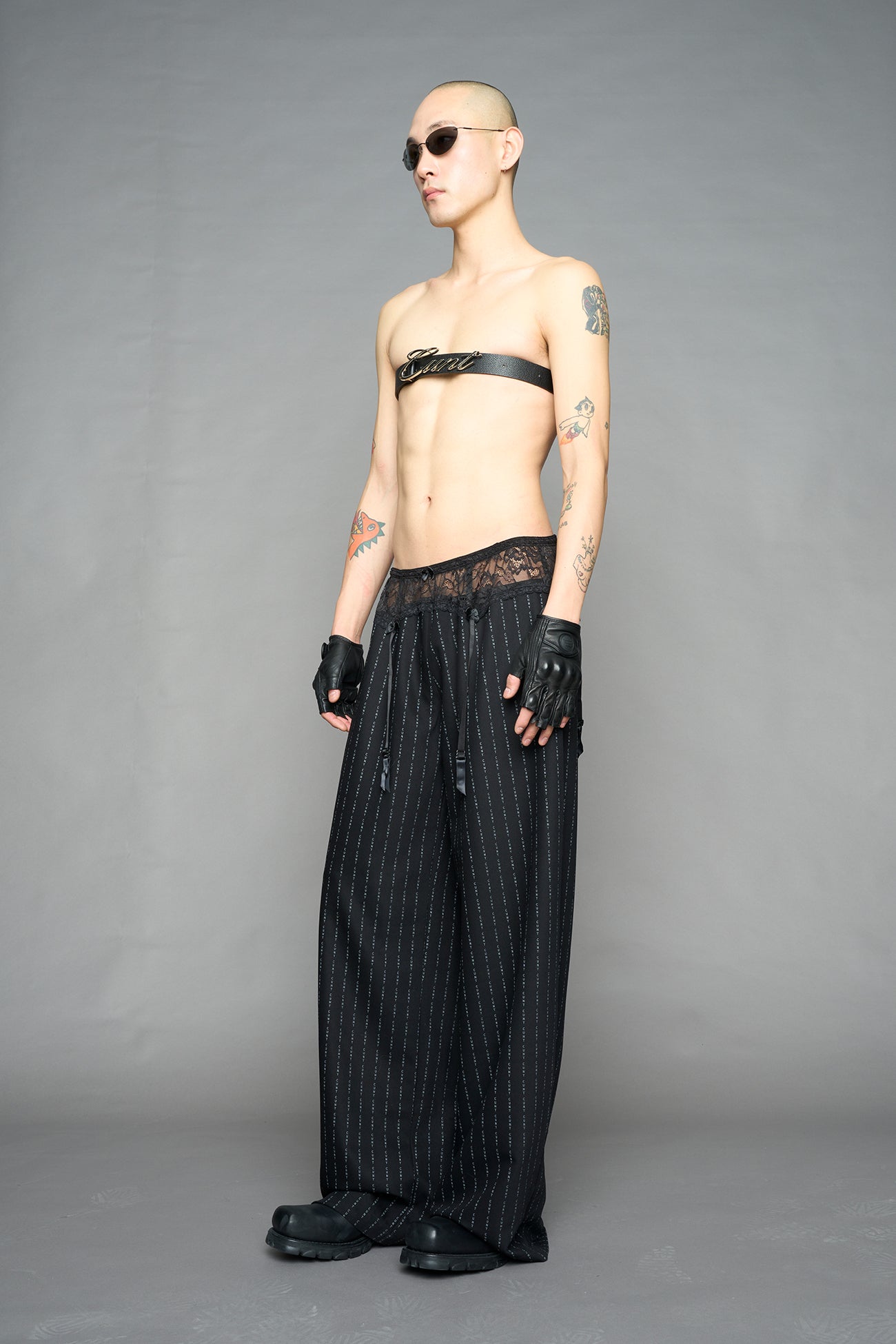 model wearing black print print baggy suiting pants with garter lace waist detail